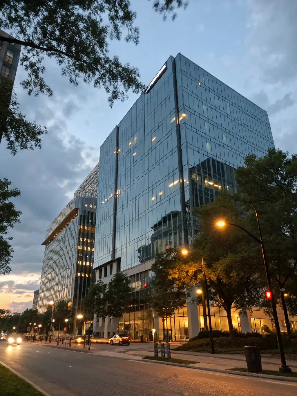 A sleek, newly completed office building with glass facades, landscaped surroundings, and clear signage, showcasing commercial construction capabilities for FacadeStory.com.
